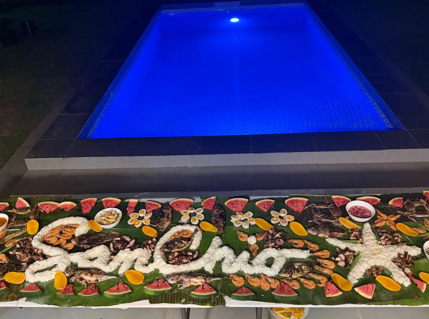A poolside boodle fight feast at SanChio Rest House