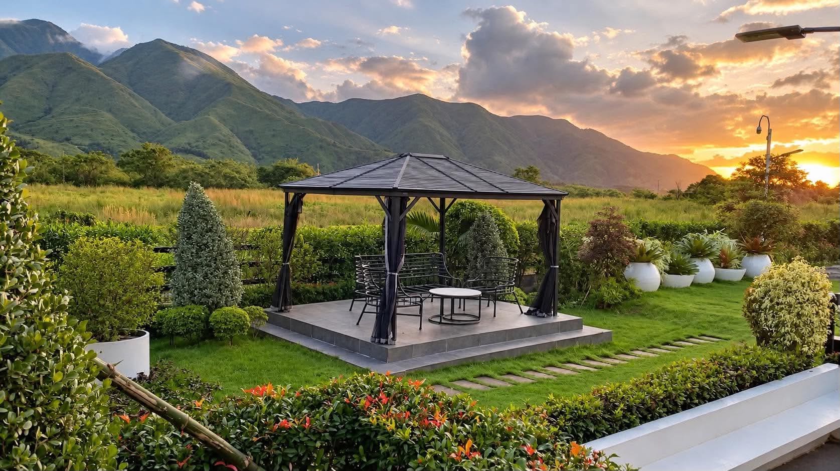 Gazebo platform framed by mountains at sunset