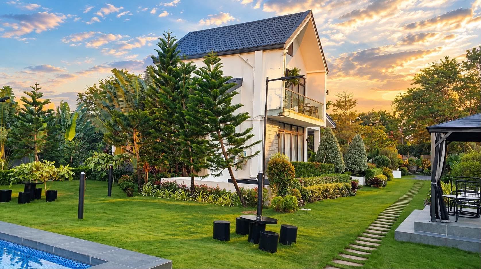 SanChio house, lawn, and pool in warm evening light